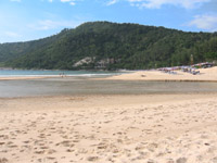A lagoon empties out into the sea at the souther end of Nai Harn Beach